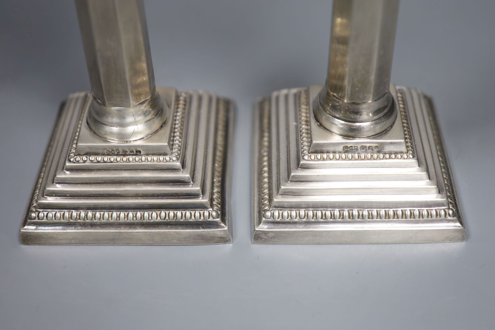 A pair of modern silver candlesticks, with panelled stems, A. Taite & Sons Ltd, London, 1957, height 27.9cm, 20.5oz.